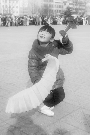 LUANNAN COUNTY - FEBRUARY 12: Girl wearing colorful clothes, performing yangko dance in the street, during the Chinese Lunar New Year, February 12, 2014, Luannan County, Hebei Province, China.のeditorial素材