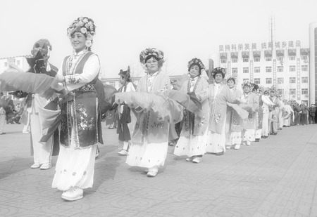 LUANNAN COUNTY - FEBRUARY 13: People wearing colorful clothes, performing yangko dance in the street, during the Chinese Lunar New Year, February 13, 2014, Luannan County, Hebei Province, China.のeditorial素材