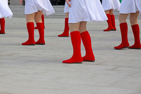 White trousers and red boots, closeup of photo