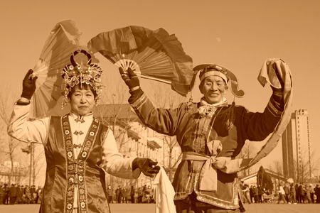 LUANNAN COUNTY - FEBRUARY 9: People wearing colorful clothes, performing yangko dance in the street, during the Chinese Lunar New Year, February 9, 2014, Luannan County, Hebei Province, China.のeditorial素材
