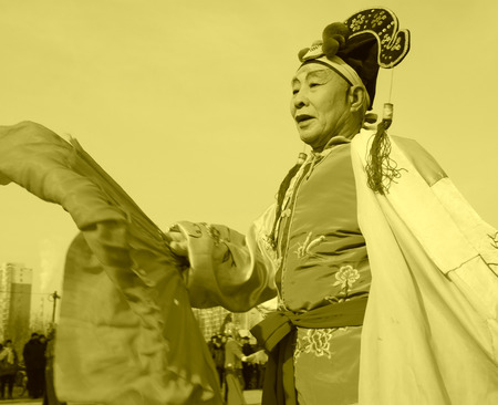 LUANNAN COUNTY - FEBRUARY 11: People wearing colorful clothes, performing yangko dance in the street, during the Chinese Lunar New Year, February 11, 2014, Luannan County, Hebei Province, China.のeditorial素材