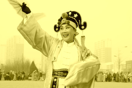 LUANNAN COUNTY - FEBRUARY 15: Performer wearing colorful clothes, performing yangko dance in the street, during the Chinese Lunar New Year, February 15, 2014, Luannan County, Hebei Province, China.のeditorial素材