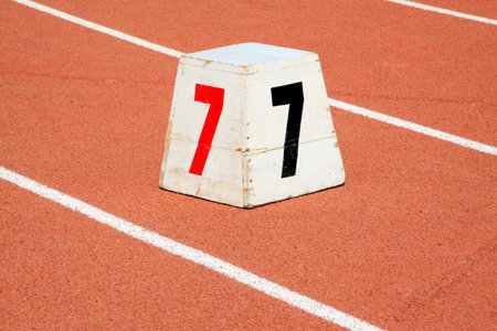 Wooden track number mark on the plastic runway, closeup of photo
