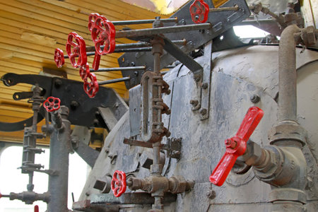 red handwheel in steam locomotive cab, closeup of photo