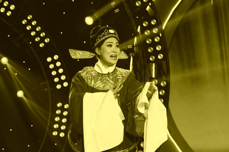 LUANNAN COUNTY - JANUARY 6: The actor wearing a sun hat performing PingJu on the stage, in the ChengZhaoCai grand theater, January 6, 2014,luannan county, hebei province, china.のeditorial素材