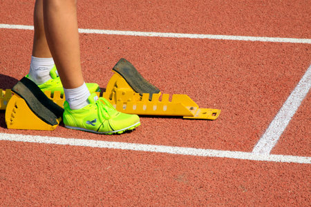 Starting blocks and the athlete's leg, closeup of photo