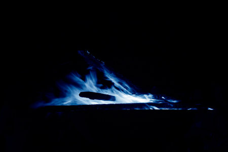 flame burning in the night, closeup of photoの写真素材