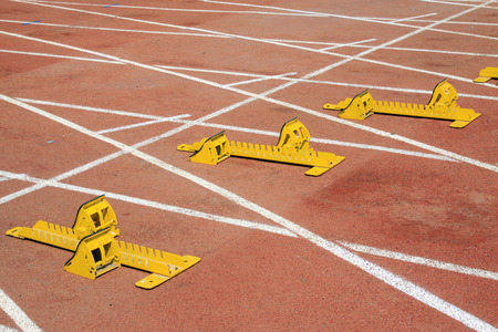 yellow starting block and athletes, closeup of photoの写真素材