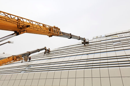 crane arm and glass curtain wall in a construction site
