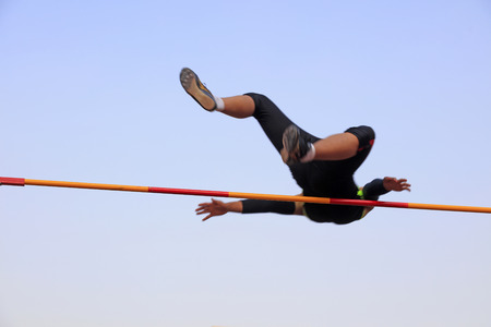 men high jump athletes in the playgroundの写真素材