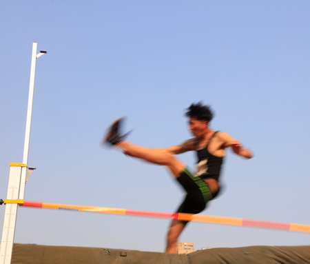 men high jump athletes in the playgroundの写真素材
