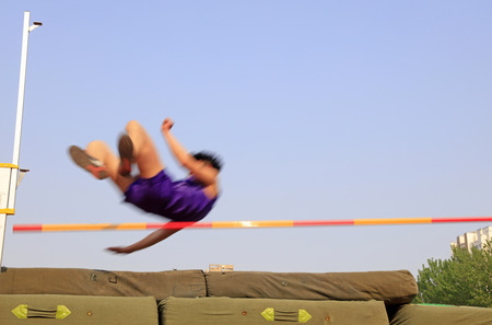 men high jump athletes in the playgroundの写真素材