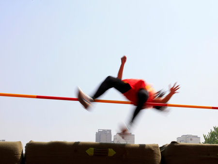 women high jump athletes in the playgroundの写真素材