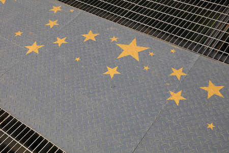 Yellow stars in the checkered plate, closeup of photoのeditorial素材