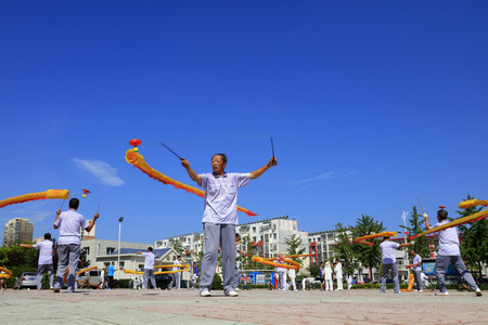 Tangshan - August 8: Diabolo performing in the park, August 8, 2016, tangshan city, hebei province, Chinaのeditorial素材