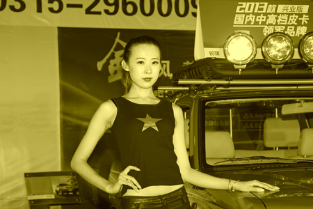 TANGSHAN - MAY 31: Beauty model in a car markets on may 31, 2014, Tangshan city, Hebei Province, Chinaのeditorial素材