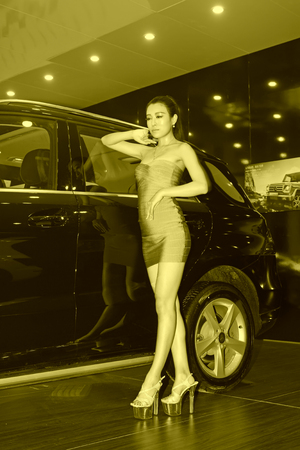 TANGSHAN - MAY 31: Beauty model in a car market on may 31, 2014, Tangshan city, Hebei Province, Chinaのeditorial素材
