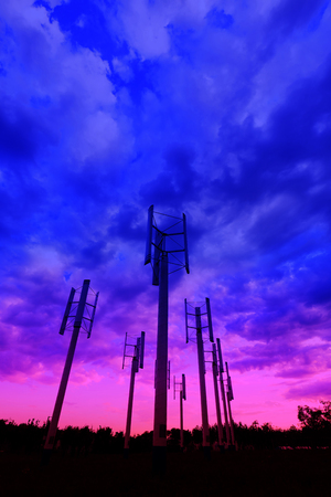 vertical axis wind turbine under blue skyの写真素材
