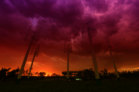 vertical axis wind turbine under blue skyの写真素材
