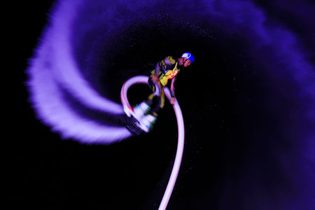 Water stunts performance at night in a park