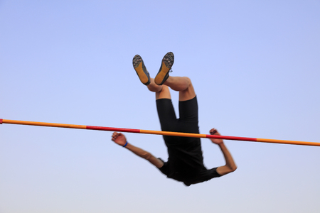 men high jump athletes in the playgroundの写真素材