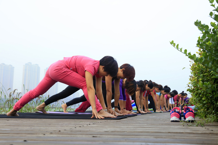 Tangshan City - September 4: women doing yoga exercise in the park, on September 4, 2016, tangshan city, hebei province, China.のeditorial素材