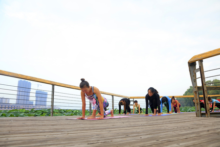 Tangshan City - September 3: women doing yoga exercise in the park, on September 3, 2016, tangshan city, hebei province, China.のeditorial素材