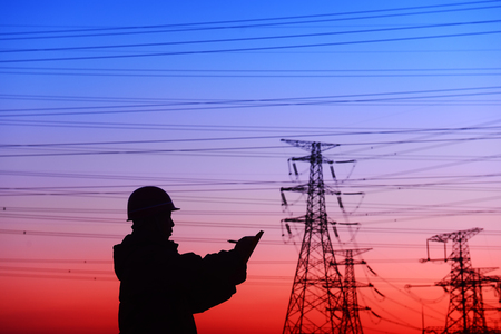 worker and electric power tower silhouetteのeditorial素材
