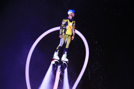 Water stunts performance at night in a parkの写真素材