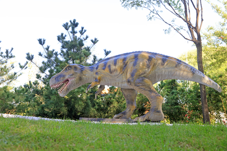 Dinosaur sculpture in a parkの写真素材