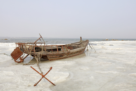 Fishing boats and anchor in the snowの写真素材