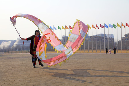 Tangshan City - February 20, 2018: people are dancing in colored silk for exercise in parks, Tangshan City, Hebei, China.のeditorial素材