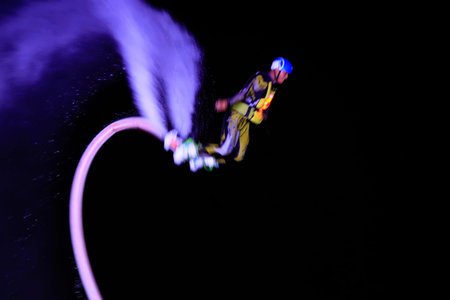 Water stunts performance at night in a park
