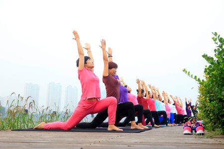 Tangshan City-September 4: women doing yoga exercise in the park, on September 4, 2016, tangshan city, hebei province, China.のeditorial素材