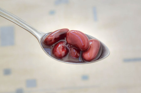 appetizing red string bean on a teaspoonの写真素材