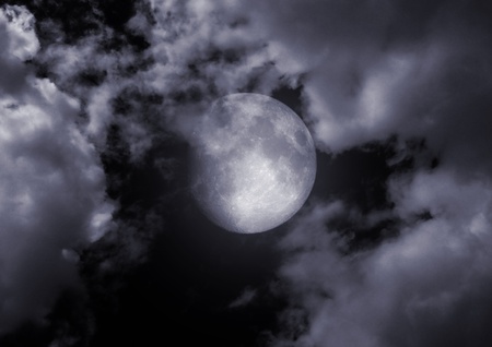 full moon in clouds の写真素材