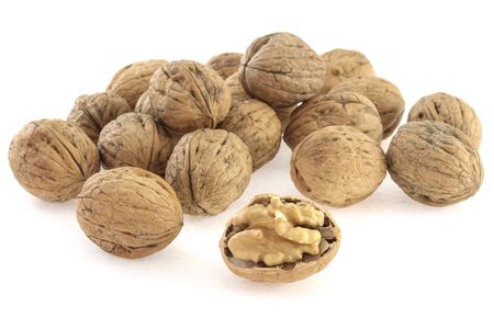 heap of walnuts in shell on white background, close-upの写真素材