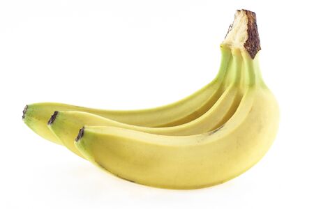 three ripe banana in the peel on a white background, close-upの写真素材