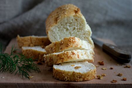 Homemade fragrant fresh bread on a boardの写真素材
