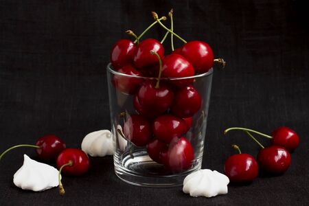 ripe cherry in a glass on a black backgroundの写真素材