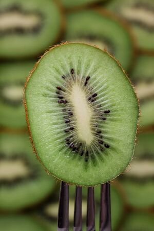 a plate of kiwi on a forkの写真素材