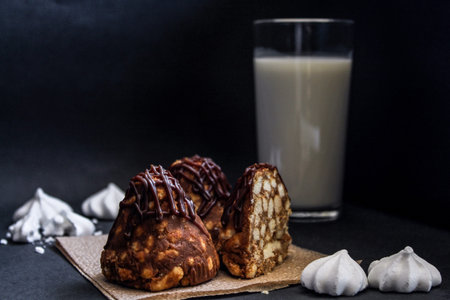 cake with caramel and nuts, sweet dessert closeup.A delicious cake on a wooden table sprinkled with powdered sugar.の写真素材