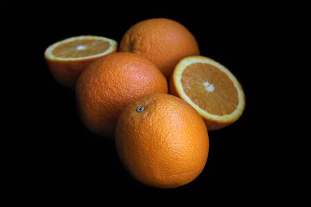 Fresh orange slice and wholle close up. black backgroundの写真素材