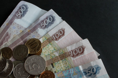 Russian paper money and a scattering of metal coins of different denominations on them
