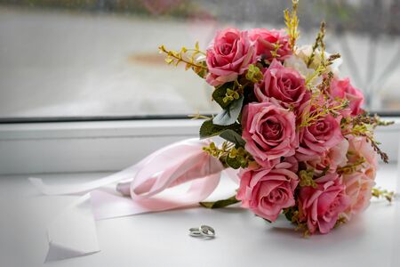 wedding bouquet with wedding ringsの写真素材