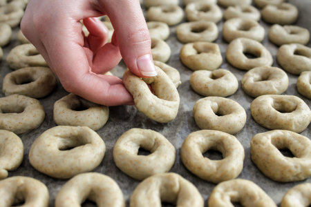 A woman putting cookie dough on a cookie sheet