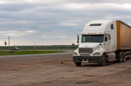 View of  truck on  road against  cloudy sky.の写真素材