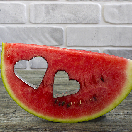 Watermelon on a gray wooden backgroundの写真素材