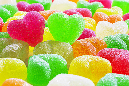 Chewing colorful marmalade jelly candies with fruit flavor close-up. Soft focus. Horizontal.の写真素材