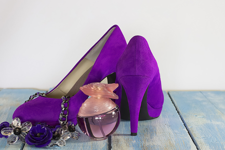 fuchsia velvet  shoes heels, necklace and perfume on white and blue wooden  background. Soft focus. Horixontal.の写真素材